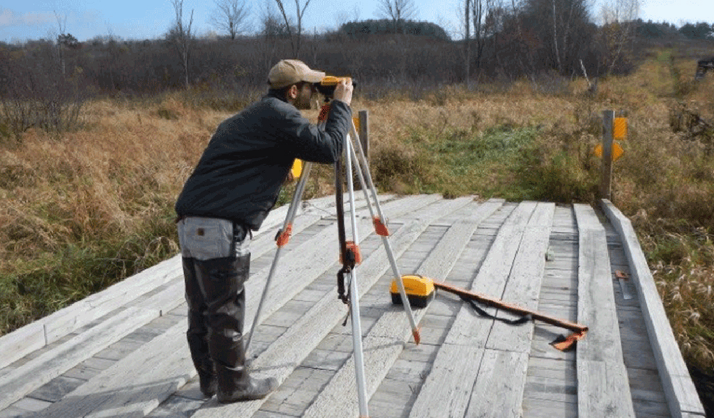 A surveyor works in the field.