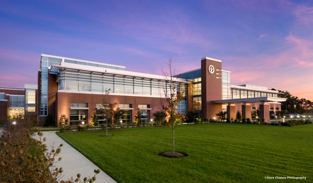 Twilight view of main entrance to LifeNet Health headquarters building.