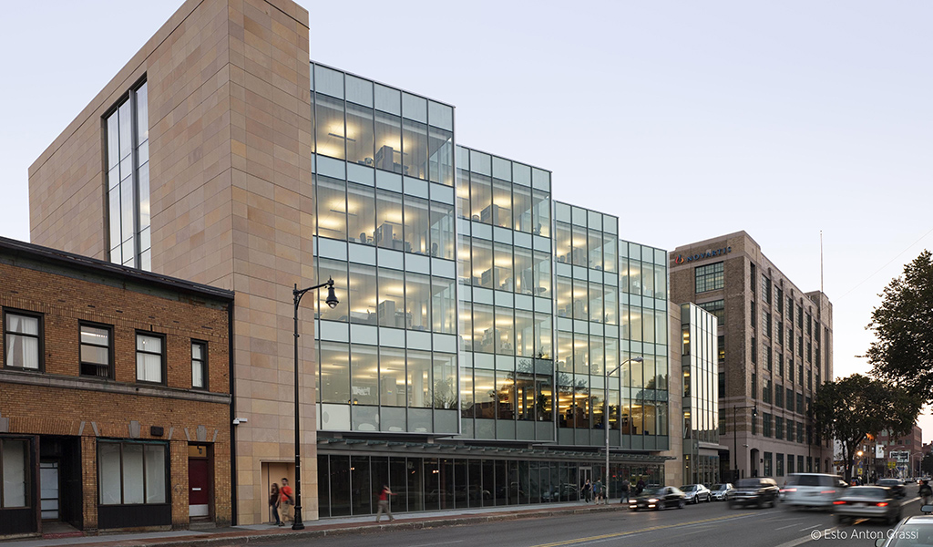 The Novartis Institutes for Biomedical Research is seen from across Massachusetts Avenue. A view of the gateway into the Novartis Institutes for Biomedical Research at dusk.