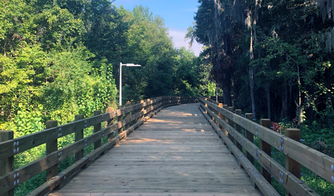 A wooden park trail in a wooded location.