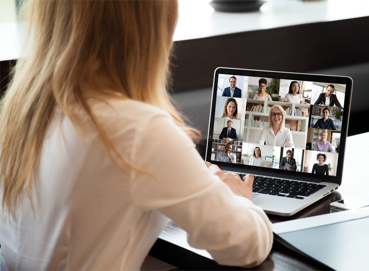 A user attends a virtual meeting on a laptop.