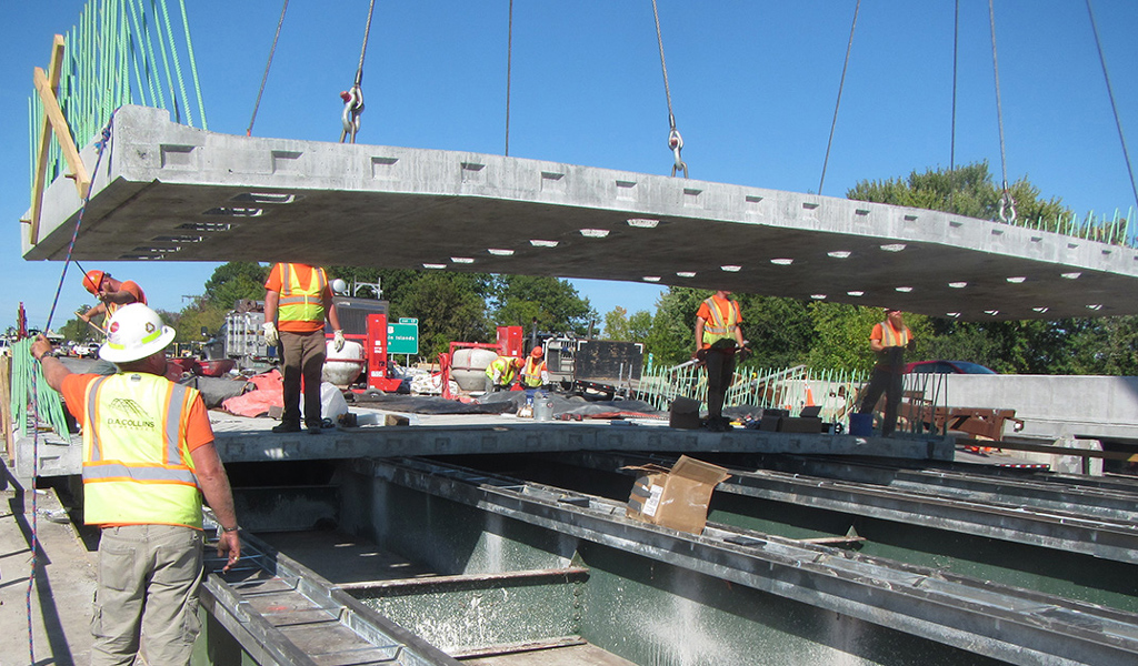 Construction personnel move part of the bridge deck into place during the Colchester Bridge replacements.