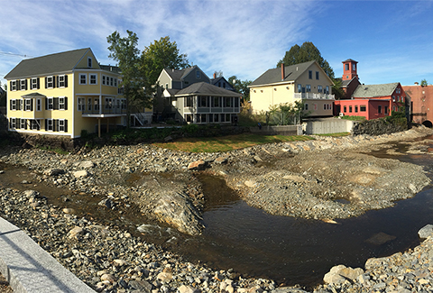 Houses line the bank of the Exeter River after the Great Dam has been removed.