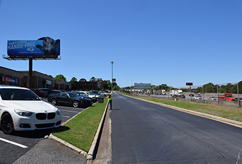 A man stands near a road alongside I-285 in Georgia.