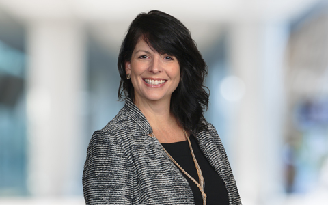 Cindy Shurling wearing a black and white tweed jacket.