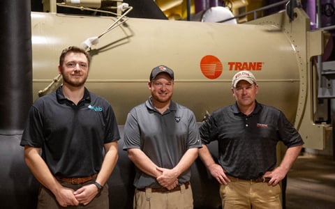 3 Men in front of new heater system 