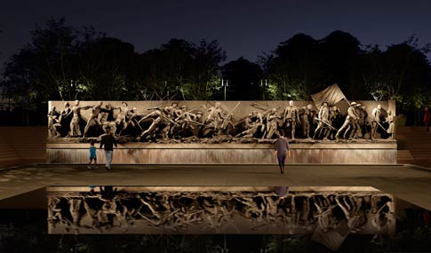 Concept Rendering nighttime lighting study across the Scrim pool area toward the central "A Soldier's Journey" sculpture