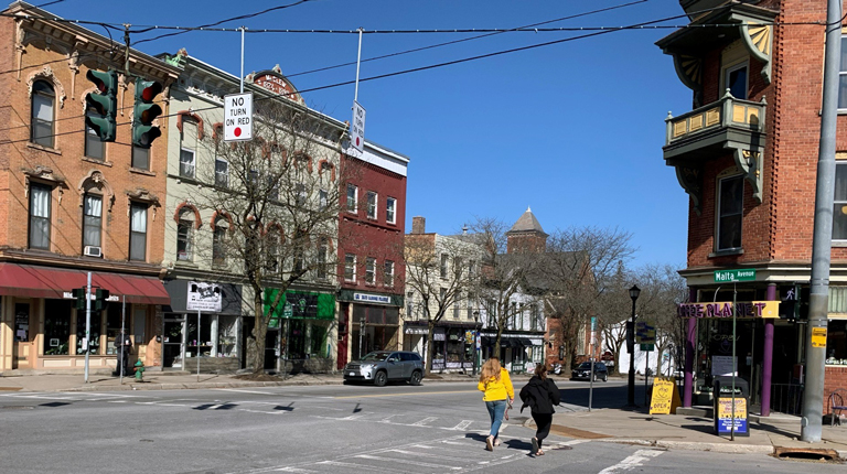 People walking across an intersection in downtown Ballston Spa.