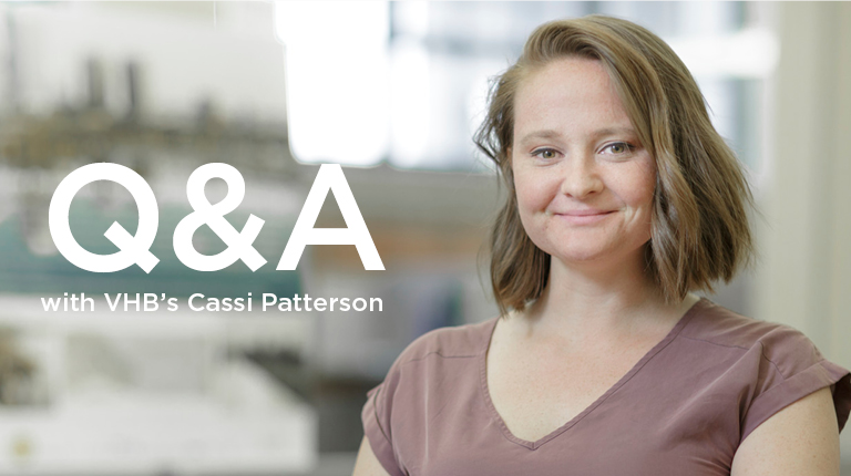 Cassi Patterson standing indoors wearing a brown shirt.