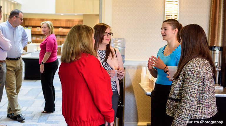 Young VHB professionals interacting at a meeting.