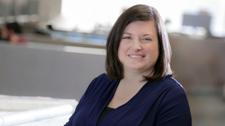 Jen McGovern sitting down wearing a navy-blue shirt.