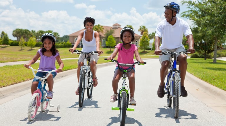 African American Family Parents and Children Cycling