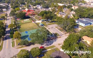 Arial of Community depicting houses, tennis court and cars