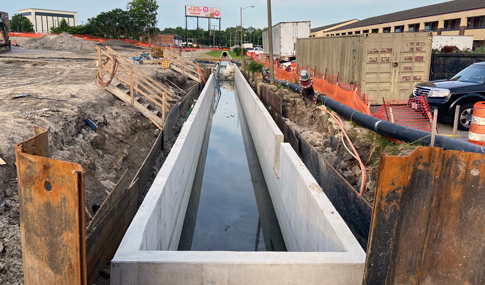 : Concrete channel at Burton Station during construction.