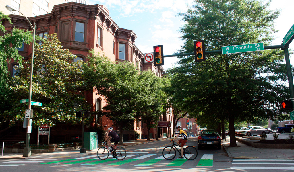 Two bicyclists travel on designated bike lane on W. Franklin Street in downtown Richmond.