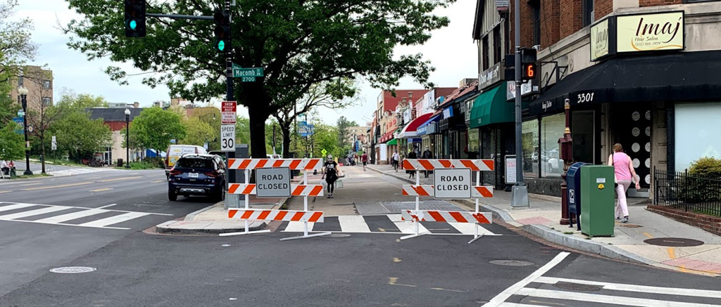 A central street with part of the road closed to vehicles.