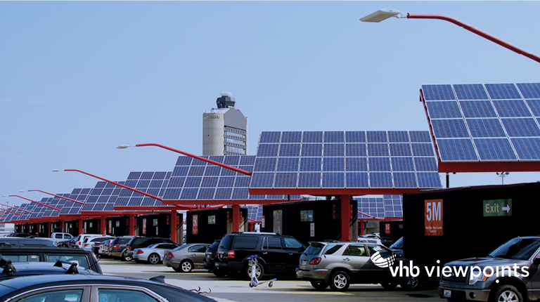 Solar panels are incorporated as part of an airport parking facility.